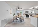 Cozy dining area next to an open kitchen featuring modern appliances and natural light at 1501 Delaware Ave, St Cloud, FL 34769