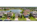 Beautiful lakefront home features a manicured lawn, lush landscaping and a brick driveway in an attractive community at 2823 Sail Breeze Way, Kissimmee, FL 34744