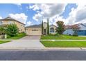Charming home features manicured lawn, lush landscaping and a brick driveway in an attractive residential neighborhood at 2823 Sail Breeze Way, Kissimmee, FL 34744