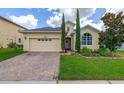 Charming one-story home with attached two-car garage, brick driveway and meticulously maintained landscaping at 2823 Sail Breeze Way, Kissimmee, FL 34744