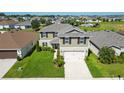 Lovely two-story home featuring a spacious yard and a community pool nearby, perfect for Gathering living at 454 Sunfish Dr, Winter Haven, FL 33881