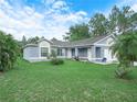 Beautiful single-story home featuring a well-manicured lawn and charming landscaping at 739 Paris Dr, Kissimmee, FL 34759