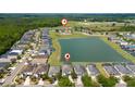 Aerial view of home near a lake and community pool with a playground at 1006 Tourmaline Dr, Kissimmee, FL 34746