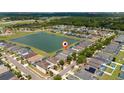 Aerial view of home in a neighborhood near a lake at 1006 Tourmaline Dr, Kissimmee, FL 34746