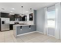 Modern kitchen featuring stainless steel appliances, granite countertops, and dark wood cabinets at 1940 Banner Ln, St Cloud, FL 34769