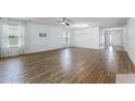 Expansive living room featuring hardwood floors, large windows, and modern lighting at 1940 Banner Ln, St Cloud, FL 34769