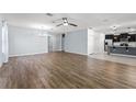 Spacious living room with hardwood floors, a ceiling fan, and ample natural light at 1940 Banner Ln, St Cloud, FL 34769
