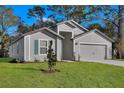 Charming home with a manicured lawn and neutral siding offers great curb appeal at 4711 Sw 136Th Pl, Ocala, FL 34473