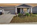 Charming single-story home with a well-maintained lawn and inviting front porch at 590 Tanaro Ln, Haines City, FL 33844