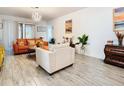 Bright living room featuring tile flooring, neutral walls, and comfortable seating at 590 Tanaro Ln, Haines City, FL 33844