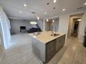 Bright kitchen showcasing a center island, stainless steel appliances, and seamless flow into the living area at 2659 Park Ridge St, Apopka, FL 32712