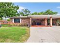 Brick home with carport, and lush landscaping at 565 Lake Mystic Ln, Lakeland, FL 33813