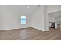 A naturally illuminated living room features stylish flooring, offering a bright and inviting space for relaxation and entertainment at 5251 Sw 164Th Street Rd, Ocala, FL 34473