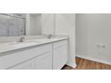Bright bathroom features a double vanity with modern fixtures and a glass-enclosed shower at 418 Marion Oaks Ln, Ocala, FL 34473