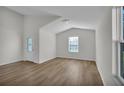 Bright living room with wood flooring, large windows, and natural light at 418 Marion Oaks Ln, Ocala, FL 34473