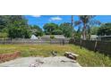 An outdoor patio space framed by a wooden fence and verdant greenery at 1814 Lowry Ave, Lakeland, FL 33801