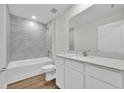 Modern bathroom with a sleek vanity, bathtub, and tiled shower for a spa-like feel at 14192 Sw 44Th Ct, Ocala, FL 34473