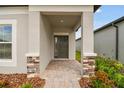 Front entrance with a covered porch and stone accents at 4837 Foxglove Cir, Lakeland, FL 33811