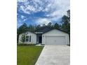 Charming single-story home with a two-car garage, and manicured lawn at 16610 Sw 50Th Cir, Ocala, FL 34473