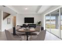 Bright living room features a dining table, couch, and a sliding glass door to the backyard at 4390 Sw 84Th Street Rd, Ocala, FL 34476