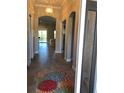 Inviting hallway with tile floors, arched doorways, and view to the living room at 7771 Lake James Blvd, Lakeland, FL 33810