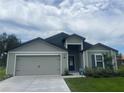 Single-story home featuring a welcoming entrance and an attached two-car garage at 4423 Sw 171St Pl, Ocala, FL 34473