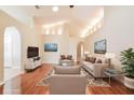 Bright living room with vaulted ceilings, hardwood floors, and ample natural light at 31817 Sunpark Cir, Leesburg, FL 34748