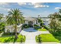 Expansive home showcasing lush landscaping, elegant architecture, and a circular driveway in a waterfront neighborhood at 9202 Bay Point Dr, Orlando, FL 32819