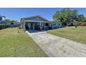 Inviting home exterior featuring a covered carport and lush green lawn at 1803 Fredricksburg Ave, Lakeland, FL 33803