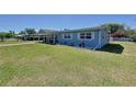 A well-kept home with a lush green lawn and meticulous landscaping at 1803 Fredricksburg Ave, Lakeland, FL 33803