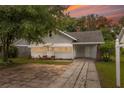 House exterior at sunset, showcasing curb appeal at 450 Avenue B Ne, Winter Haven, FL 33881