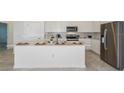 Modern kitchen with stainless steel appliances and a large island at 6843 Sw 90Th Loop, Ocala, FL 34476