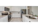 Modern kitchen with stainless steel appliances and an island at 6843 Sw 90Th Loop, Ocala, FL 34476