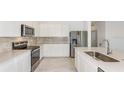 Modern kitchen with stainless steel appliances and light cabinets at 6833 Sw 90Th Loop, Ocala, FL 34476