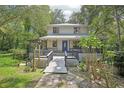 Inviting home featuring a covered front porch, well-maintained landscaping, and a welcoming walkway at 3603 Cr 626N, Bushnell, FL 33513