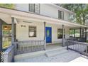Covered porch with gray railings and blue front door, offering a relaxing outdoor space at 3603 Cr 626N, Bushnell, FL 33513
