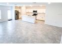 Modern kitchen with stainless steel appliances, white cabinets, and large center island at 752 Reggie Rd, Winter Haven, FL 33884