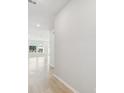 Bright and spacious hallway with light walls and wood-look flooring at 3068 Bootlace Way, St Cloud, FL 34771