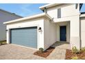 Front view of a one-story home with gray garage door at 5783 Greenery Ln, St Cloud, FL 34771