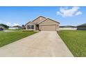 Charming single-Gathering home with a manicured lawn, neat flowerbeds, and a two-car garage at 684 Se 65Th Ter, Ocala, FL 34472