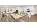 Light and airy dining area with wood table and seating for six at 2068 Marigold Aly, Winter Haven, FL 33884