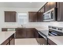 Modern kitchen with stainless steel appliances and dark cabinetry at 4416 Sw 84Th Street Rd, Ocala, FL 34476