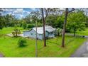 Aerial view of a well maintained home featuring a metal roof and a spacious, lush green yard at 323 Nw 25Th St, Ocala, FL 34475