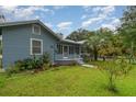 Charming home with a cozy porch, fresh paint, landscaping, and a well-maintained lawn at 323 Nw 25Th St, Ocala, FL 34475