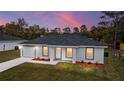Beautiful exterior of home with landscaping and a lovely pink sky at dusk at 15499 Sw 27Th Ln, Ocala, FL 34481
