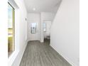 Bright entryway with gray vinyl flooring and powder room at 3728 Bergamot St, Lake Alfred, FL 33850
