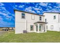 Two story house with covered patio and grassy backyard at 3740 Bergamot St, Lake Alfred, FL 33850