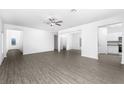 Spacious living room with gray vinyl plank flooring and an open floor plan at 3744 Bergamot St, Lake Alfred, FL 33850
