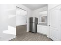 Kitchen with stainless steel refrigerator and white cabinets at 3732 Bergamot St, Lake Alfred, FL 33850