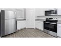 Stainless steel appliances and white cabinets highlight this kitchen at 3732 Bergamot St, Lake Alfred, FL 33850